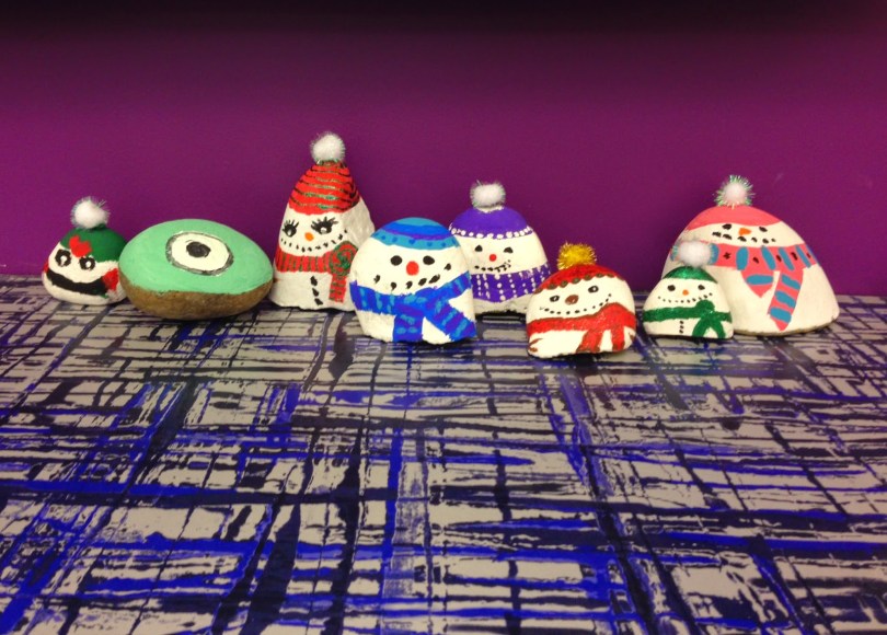 Small rocks painted as snowmen.